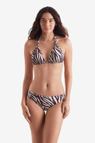 Woman wearing a zebra print bikini top with zebra print swim bottoms