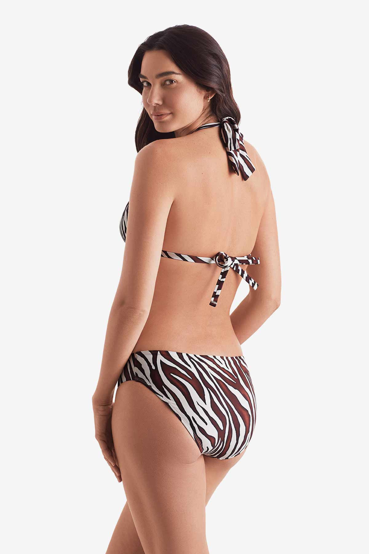 Woman turned left wearing a zebra print bikini top with zebra print swim bottoms