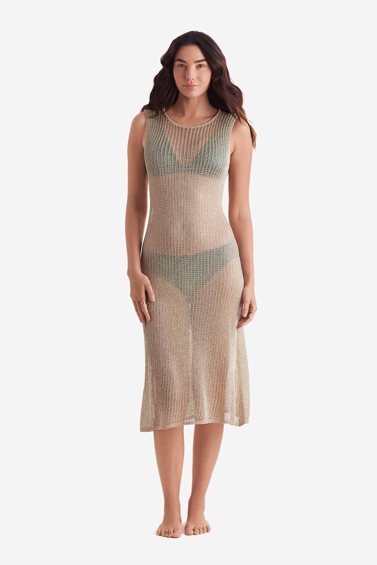 Woman wearing a gold metallic knit swim dress cover up