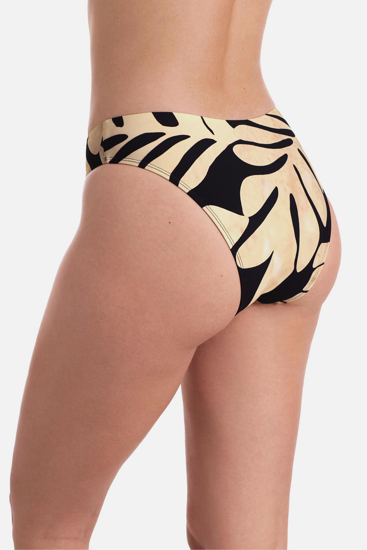 Back view of large tan and black palm leaf printed low rise swim bottoms