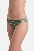 Side view of multicolored leaf printed swim bottoms with side cutouts 