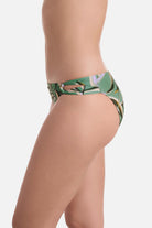 Side view of multicolored leaf printed swim bottoms with side cutouts 