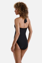 Woman turned left wearing a black high neck one-piece swimsuit with frills along the edges