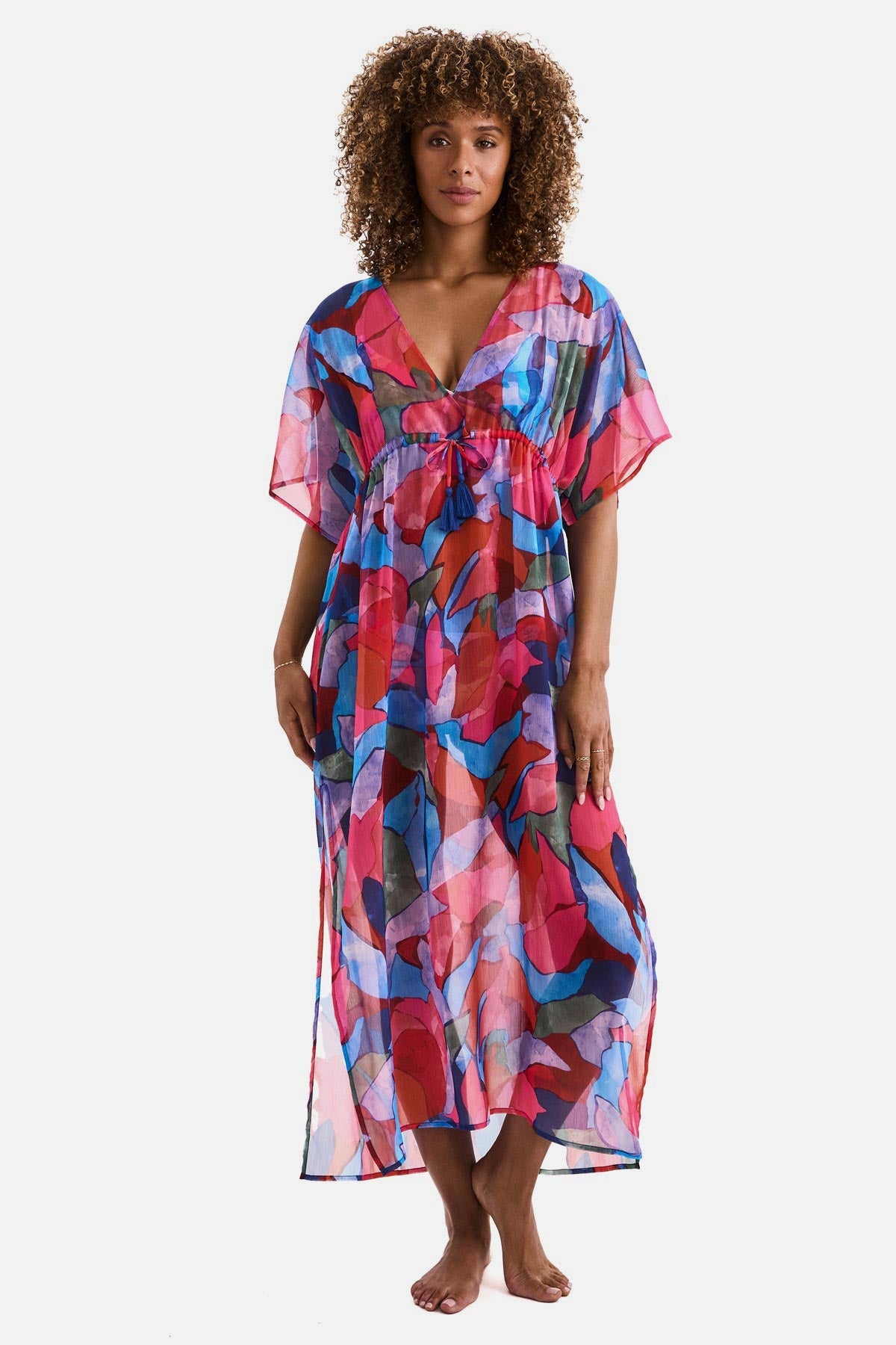 Woman wearing a multicolored abstract printed sheer swim cover up