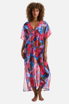 Woman wearing a multicolored abstract printed sheer swim cover up
