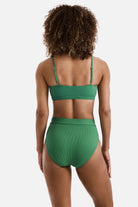 Woman turned away wearing a green ribbed bralette swim top with matching swim bottoms