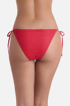 Back view of coral colored side tie swim bottoms