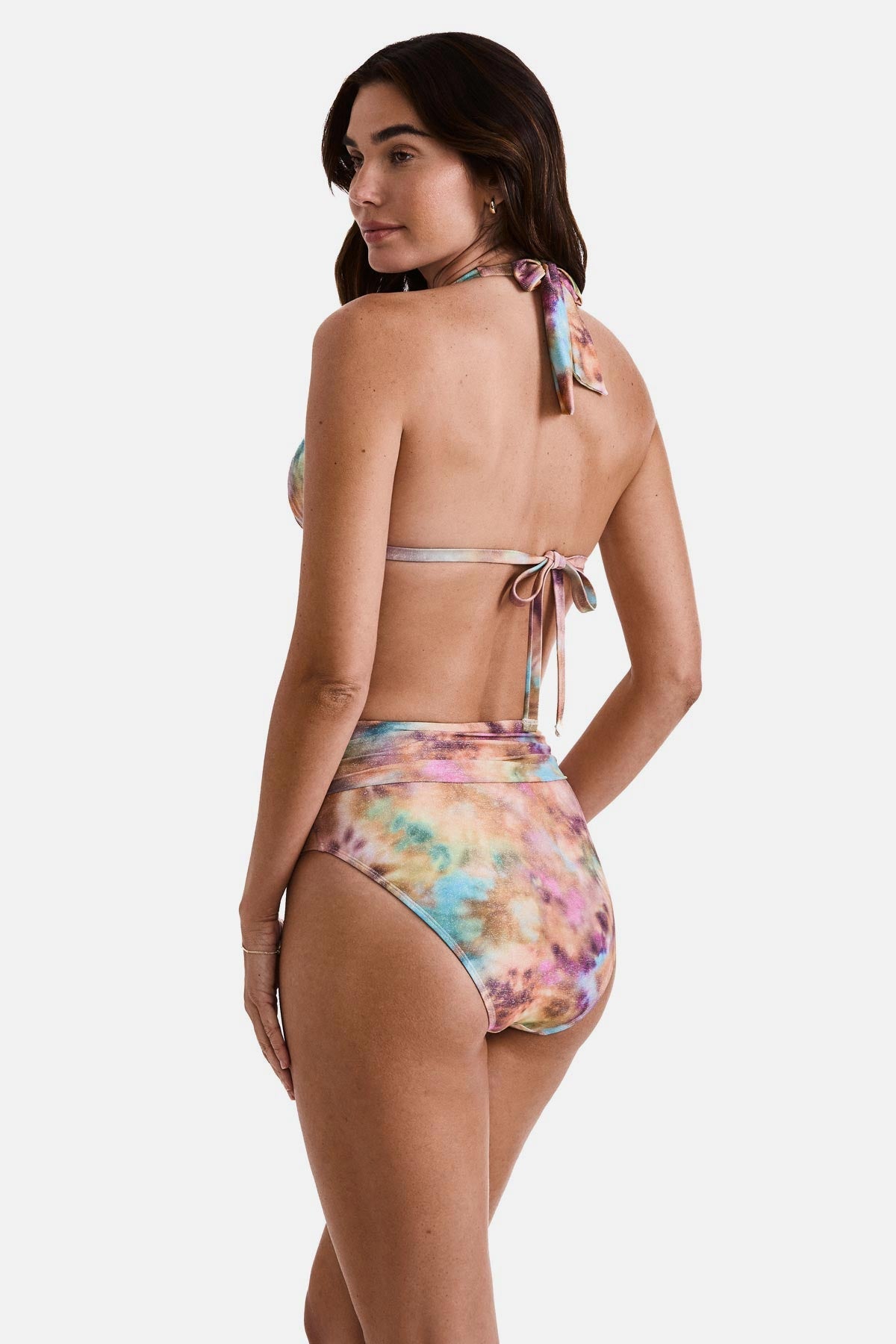 Woman turned left wearing a tie dye bikini top with matching swim bottoms