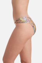 Side view of tie dye swim bottoms with side cutouts 