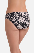 Back view of low rise black and white palm tree printed swim bottoms