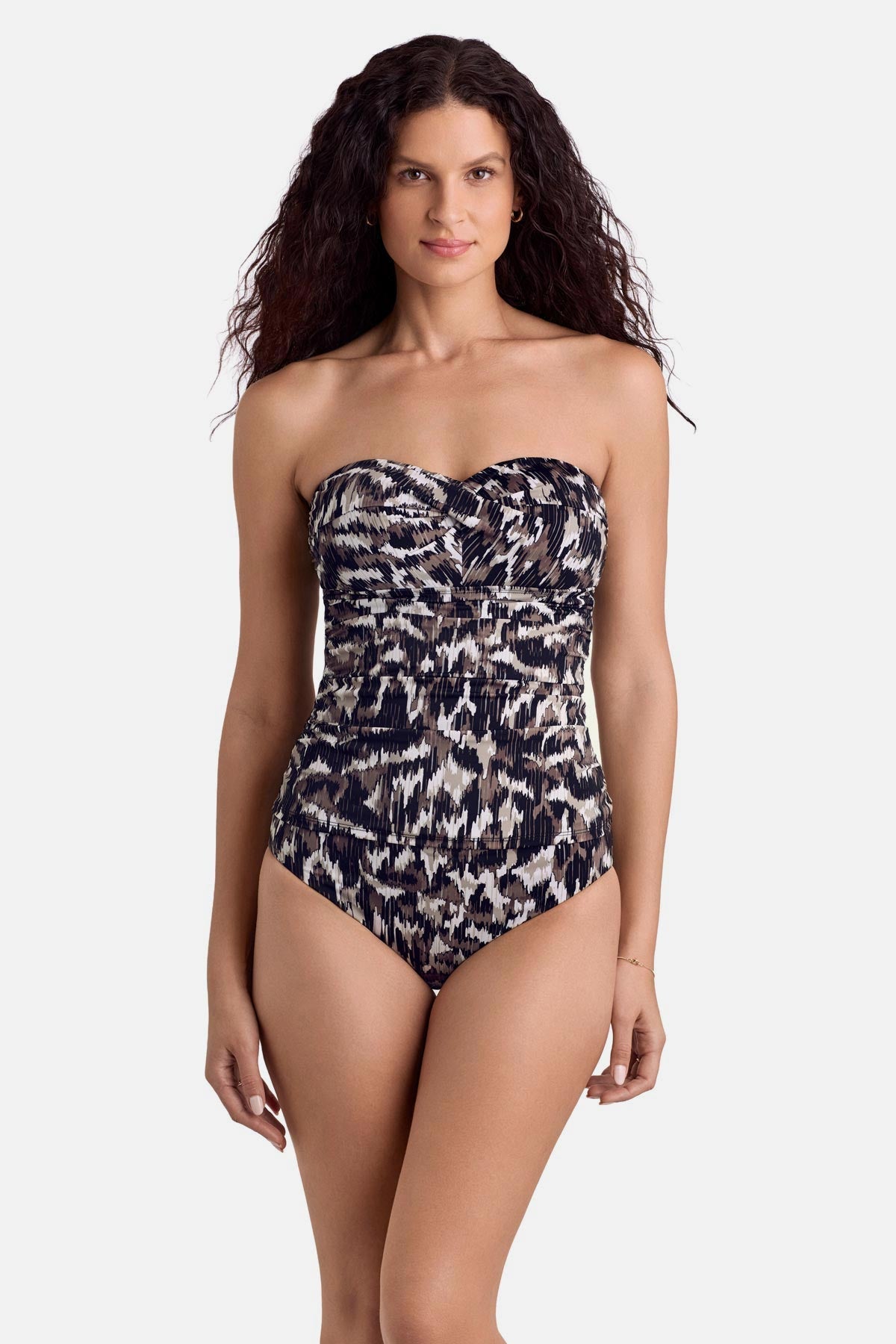 Woman wearing an animal skin print bandeau tankini top with matching swim bottoms