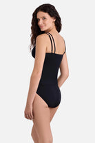 Woman turned left wearing a black tankini top with matching swim bottoms